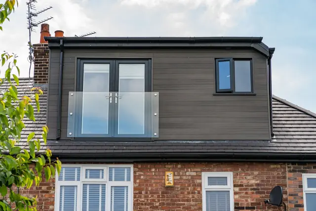 Finished loft conversion exterior with dormer and glazed Juliet balcony