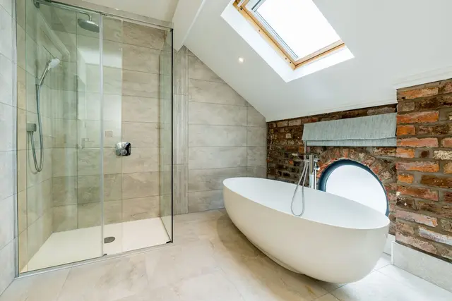 Renovated bathroom with freestanding bath, shower and roof light