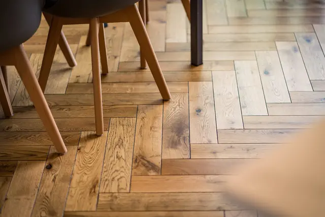 Close-up of herringbone timber flooring in a renovated room